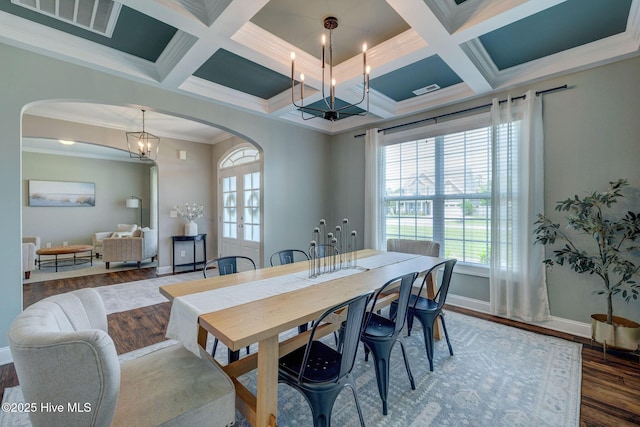 110 E Conolly Ct, Hampstead, NC 28443 - dining space with arched walkways, wood finished floors, plenty of natural light, a chandelier, and beamed ceiling