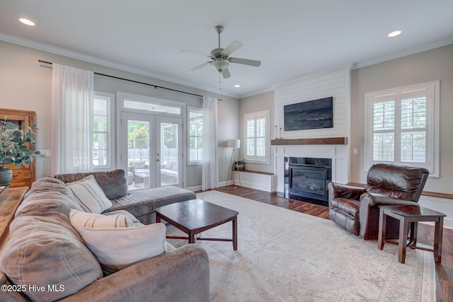 110 E Conolly Ct, Hampstead, NC 28443 - living area with wood finished floors, ornamental molding, french doors, ceiling fan, and a fireplace