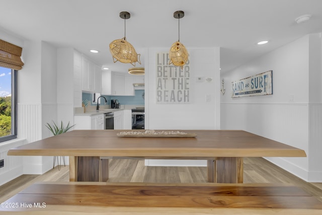 8801 Reed Dr Unit 116West, Emerald Isle, NC 28594 - unfurnished dining area featuring wainscoting, light wood-style floors, and recessed lighting