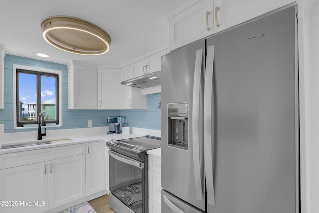 8801 Reed Dr Unit 116West, Emerald Isle, NC 28594 - kitchen featuring stainless steel appliances, under cabinet range hood, light countertops, and white cabinetry