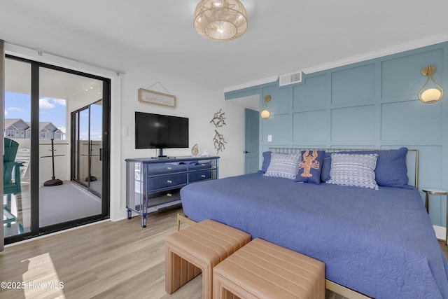 8801 Reed Dr Unit 116West, Emerald Isle, NC 28594 - bedroom with access to exterior, light wood finished floors, and a decorative wall