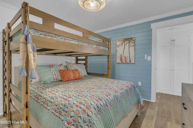 8801 Reed Dr Unit 116West, Emerald Isle, NC 28594 - bedroom with ornamental molding, wood finished floors, and wooden walls