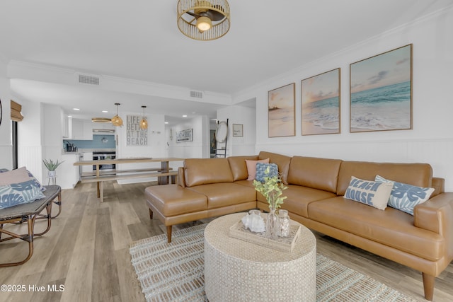 8801 Reed Dr Unit 116West, Emerald Isle, NC 28594 - living area with light wood-style floors, ornamental molding, and wainscoting