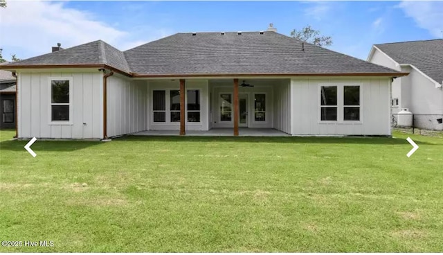 209 Planters Ridge Dr, Sunset Beach, NC 28468 - rear view of property with board and batten siding, a patio area, a yard, a shingled roof, and a chimney