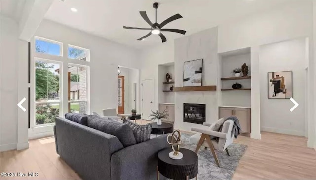 209 Planters Ridge Dr, Sunset Beach, NC 28468 - living area with plenty of natural light, ceiling fan, light wood-style flooring, and a glass covered fireplace