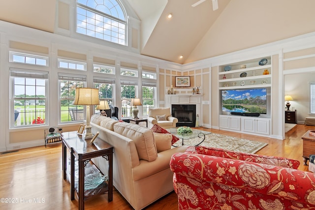 2710 Scarborough Way, Southport, NC 28461 - living room with high vaulted ceiling, a fireplace, wood finished floors, and built in features