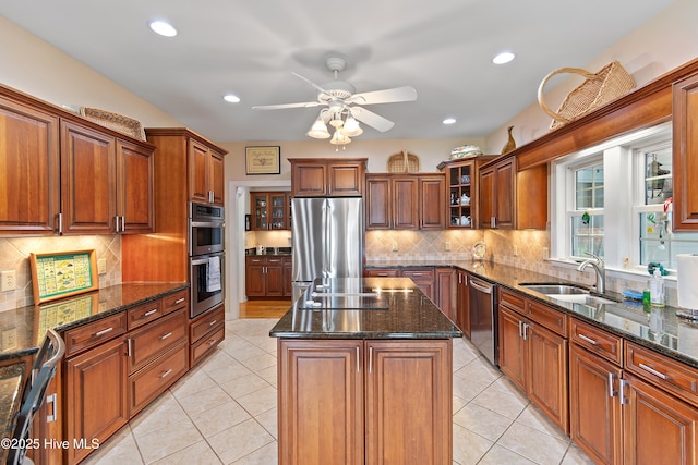 2710 Scarborough Way, Southport, NC 28461 - kitchen featuring stainless steel appliances, a center island, ceiling fan, brown cabinetry, and backsplash
