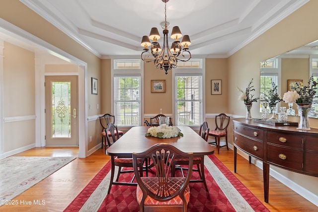 2710 Scarborough Way, Southport, NC 28461 - dining space with a chandelier, wood finished floors, and a tray ceiling