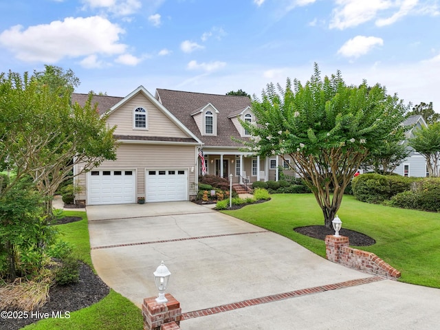 2710 Scarborough Way, Southport, NC 28461 - view of front facade with driveway, covered porch, a front lawn, roof with shingles, and a garage
