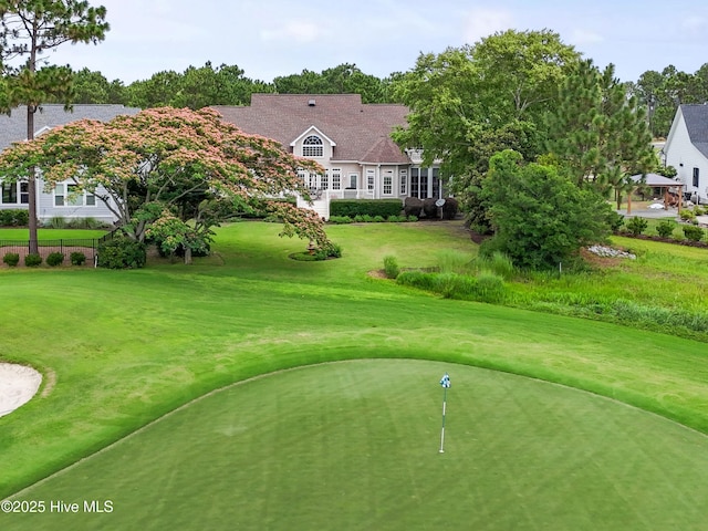 2710 Scarborough Way, Southport, NC 28461 - surrounding community with golf course view, a lawn, and a putting green