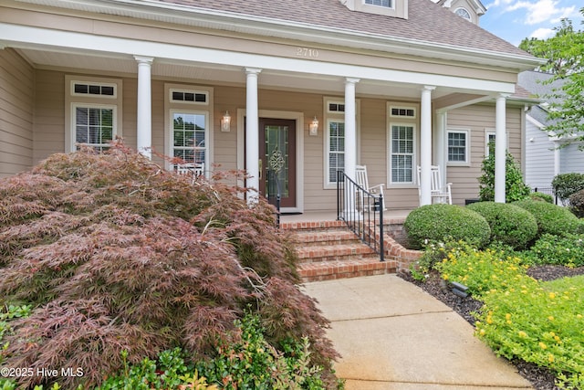 2710 Scarborough Way, Southport, NC 28461 - view of exterior entry with a shingled roof and covered porch