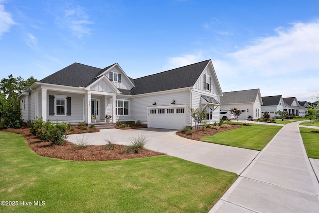 523 Trisail Ter, Wilmington, NC 28412 - modern inspired farmhouse featuring board and batten siding, a front lawn, driveway, covered porch, and roof with shingles