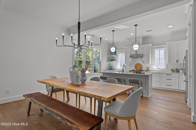 523 Trisail Ter, Wilmington, NC 28412 - dining room with a chandelier, light wood-style floors, recessed lighting, and ornamental molding