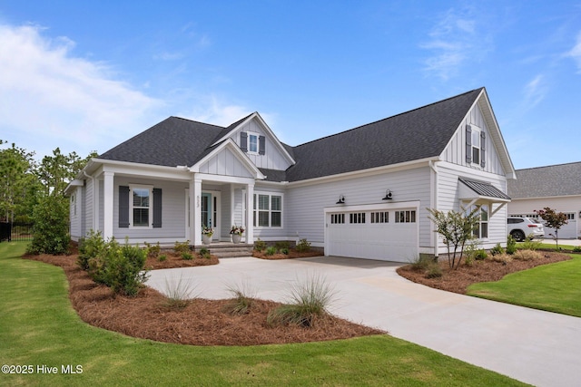 523 Trisail Ter, Wilmington, NC 28412 - modern farmhouse style home with board and batten siding, concrete driveway, a front yard, a garage, and covered porch