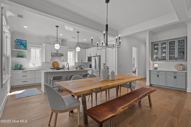 523 Trisail Ter, Wilmington, NC 28412 - dining area featuring light wood-style floors, recessed lighting, crown molding, and a chandelier