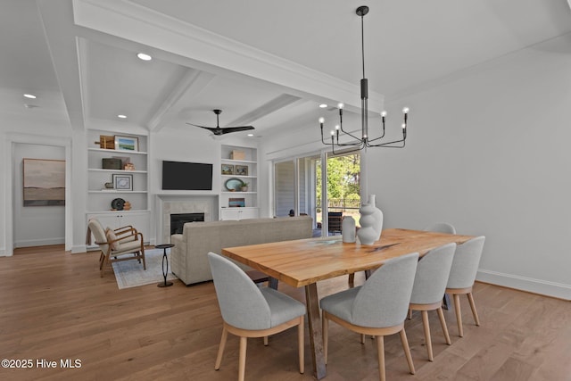 523 Trisail Ter, Wilmington, NC 28412 - dining area with beam ceiling, a fireplace, recessed lighting, light wood finished floors, and crown molding