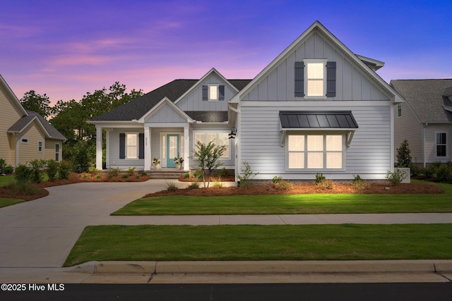 523 Trisail Ter, Wilmington, NC 28412 - modern farmhouse style home with board and batten siding, a standing seam roof, a lawn, and a metal roof