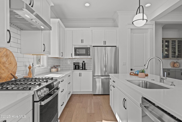 523 Trisail Ter, Wilmington, NC 28412 - kitchen with stainless steel appliances, range hood, light countertops, white cabinets, and recessed lighting