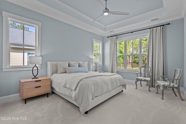 523 Trisail Ter, Wilmington, NC 28412 - bedroom featuring a tray ceiling, light colored carpet, ornamental molding, and a ceiling fan