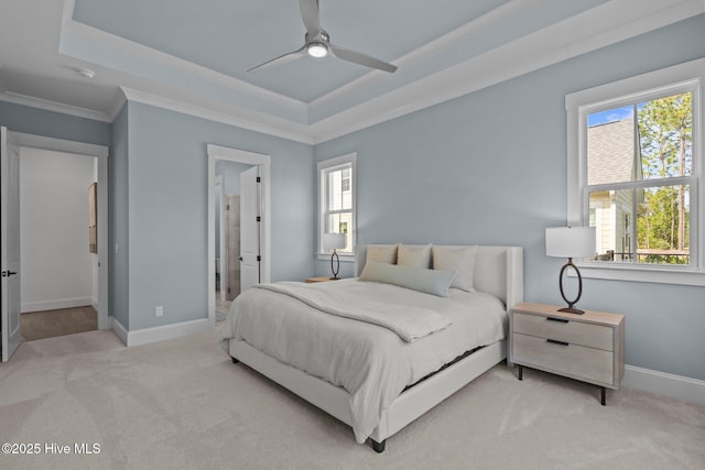523 Trisail Ter, Wilmington, NC 28412 - carpeted bedroom featuring multiple windows, a tray ceiling, crown molding, ensuite bath, and ceiling fan
