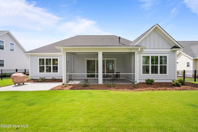 523 Trisail Ter, Wilmington, NC 28412 - rear view of house featuring board and batten siding, a patio area, a sunroom, and a shingled roof
