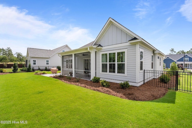 523 Trisail Ter, Wilmington, NC 28412 - back of property featuring a sunroom, board and batten siding, a fenced backyard, and a ceiling fan