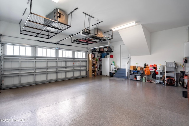 523 Trisail Ter, Wilmington, NC 28412 - garage with a garage door opener and freestanding refrigerator