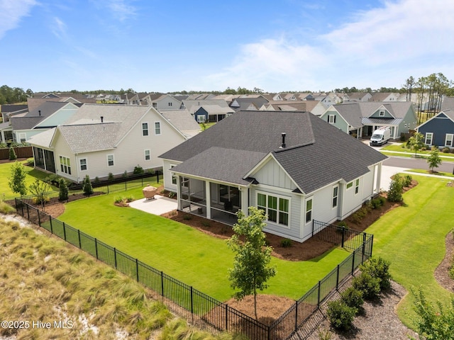 523 Trisail Ter, Wilmington, NC 28412 - back of house featuring board and batten siding, roof with shingles, a residential view, a patio, and a fenced backyard