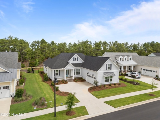 523 Trisail Ter, Wilmington, NC 28412 - view of front of home featuring driveway, board and batten siding, a front yard, a porch, and an attached garage