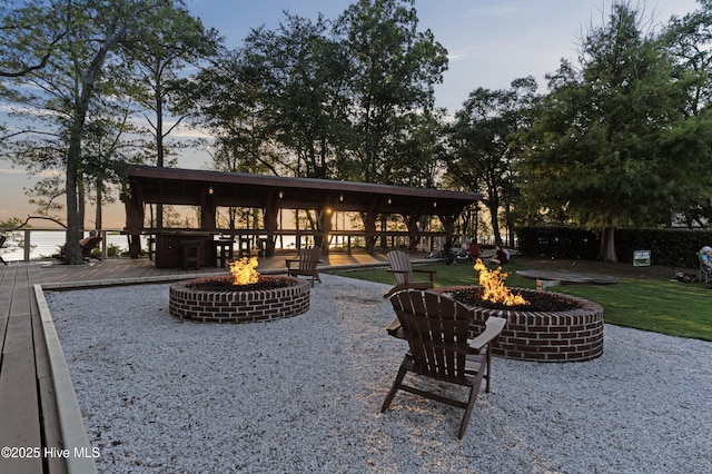 523 Trisail Ter, Wilmington, NC 28412 - back of property featuring an outdoor fire pit and a wooden deck