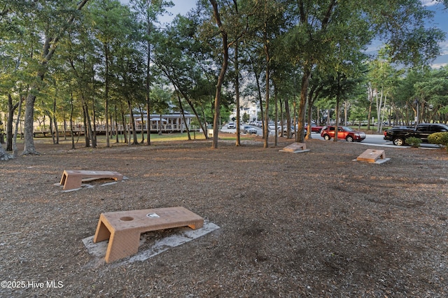523 Trisail Ter, Wilmington, NC 28412 - view of parking / parking lot with view of wooded area