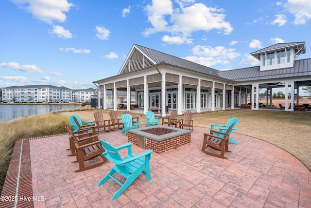 523 Trisail Ter, Wilmington, NC 28412 - view of patio / terrace featuring a fire pit and a water view