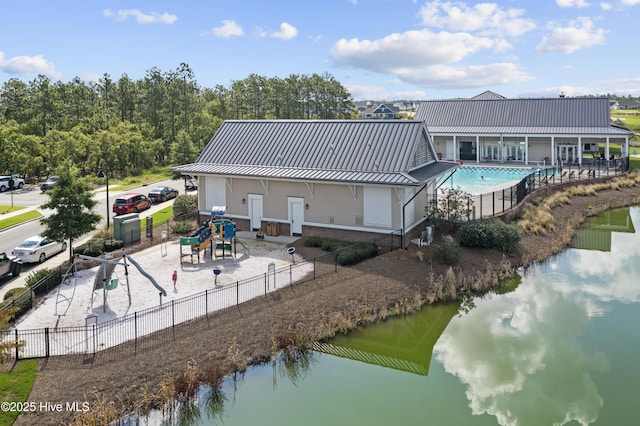 523 Trisail Ter, Wilmington, NC 28412 - back of property featuring a metal roof, a community pool, a standing seam roof, and a water view