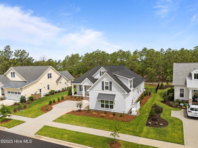 523 Trisail Ter, Wilmington, NC 28412 - view of front of home with board and batten siding, concrete driveway, and a front lawn