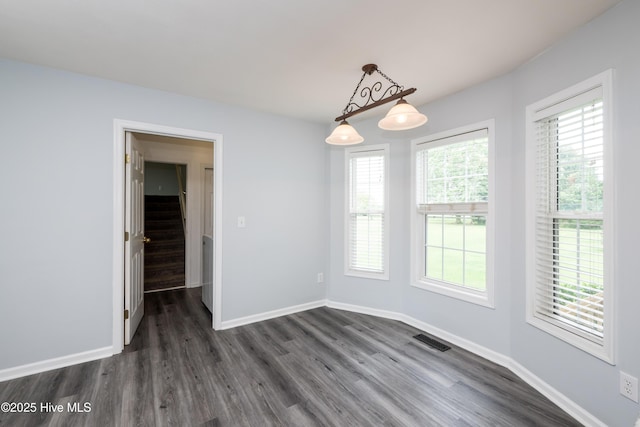 115 Billets Bridge Rd, Camden, NC 27921 - unfurnished dining area with dark wood finished floors and stairway