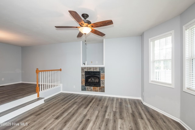 115 Billets Bridge Rd, Camden, NC 27921 - unfurnished living room with wood finished floors, a ceiling fan, a tile fireplace, and heating unit