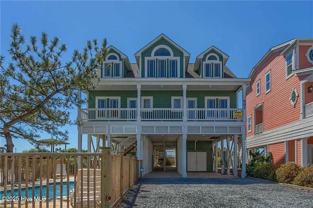 887 Ocean Blvd W, Holden Beach, NC 28462 - view of front facade with a carport, gravel driveway, and stairs
