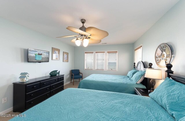 887 Ocean Blvd W, Holden Beach, NC 28462 - carpeted bedroom with baseboards and ceiling fan