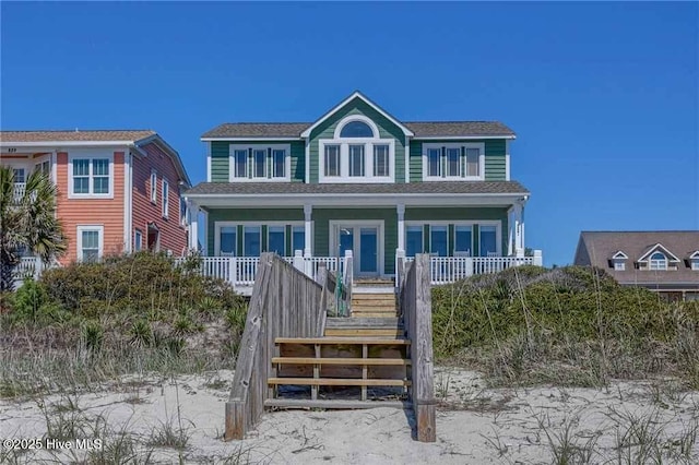 887 Ocean Blvd W, Holden Beach, NC 28462 - view of front of home with covered porch, stairway, and roof with shingles