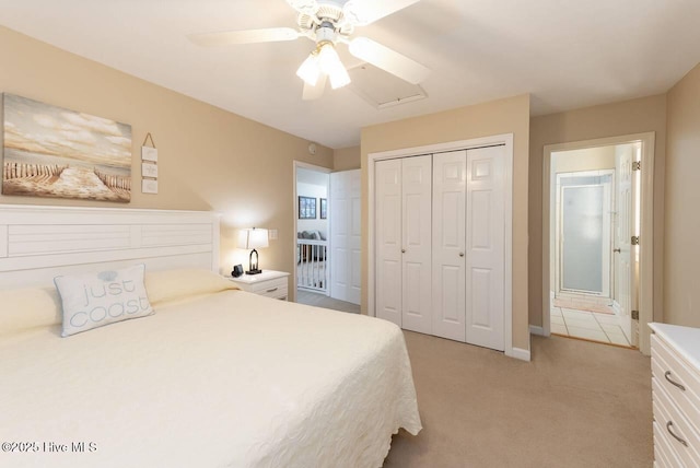 887 Ocean Blvd W, Holden Beach, NC 28462 - bedroom featuring light carpet, a closet, ceiling fan, and connected bathroom