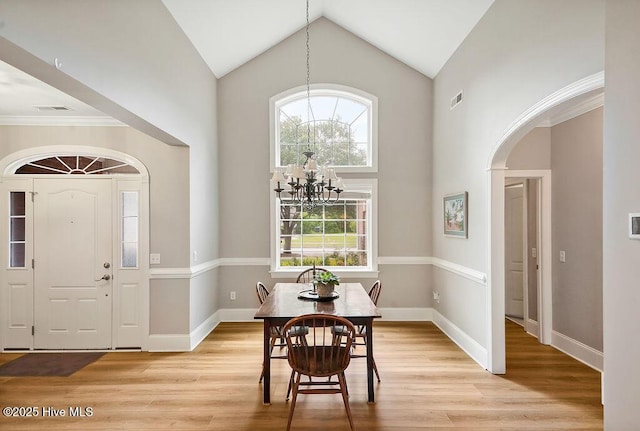 428 Windchime Dr, Wilmington, NC 28412 - dining space with a chandelier, healthy amount of natural light, light wood-style flooring, and high vaulted ceiling