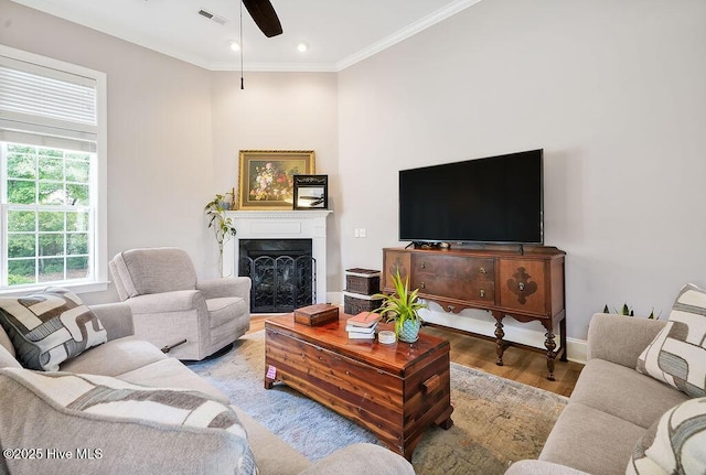 428 Windchime Dr, Wilmington, NC 28412 - living room featuring wood finished floors, ornamental molding, a ceiling fan, a fireplace, and recessed lighting