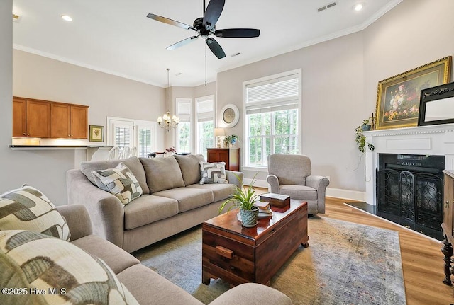 428 Windchime Dr, Wilmington, NC 28412 - living area featuring a chandelier, ceiling fan, wood finished floors, recessed lighting, and a fireplace