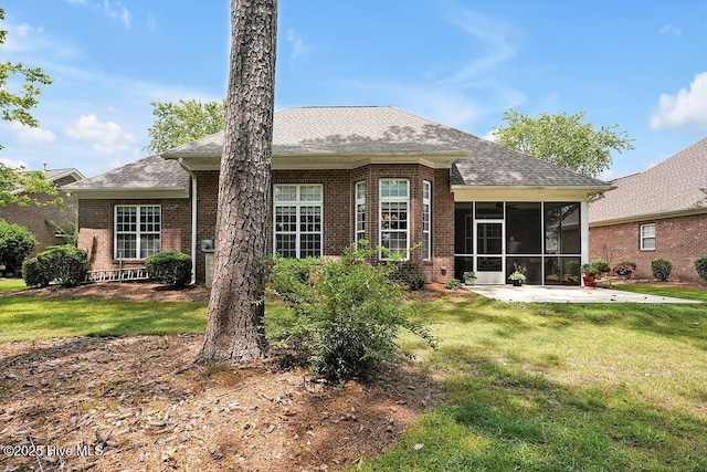428 Windchime Dr, Wilmington, NC 28412 - back of house with a sunroom, a lawn, brick siding, and a shingled roof