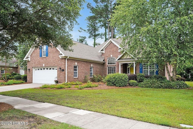 428 Windchime Dr, Wilmington, NC 28412 - traditional-style home featuring brick siding, a garage, driveway, and a front yard