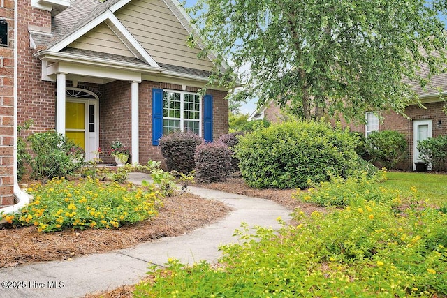 428 Windchime Dr, Wilmington, NC 28412 - property entrance featuring brick siding and a shingled roof