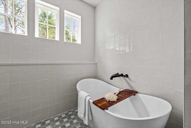 575 E Morganton Rd, Southern Pines, NC 28387 - full bath featuring tile walls, a freestanding tub, and tile patterned flooring