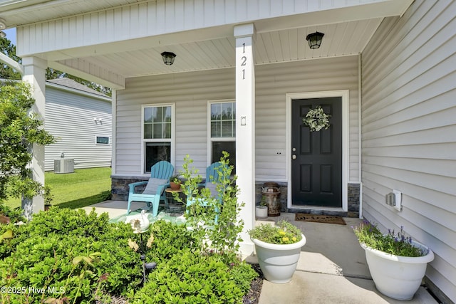 121 Poplar Branch Way, Hampstead, NC 28443 - doorway to property with stone siding and covered porch