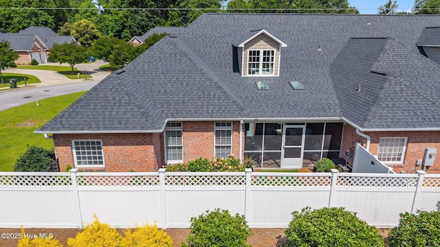 812 Vineyard Dr, New Bern, NC 28562 - view of front of house with brick siding, roof with shingles, and a sunroom