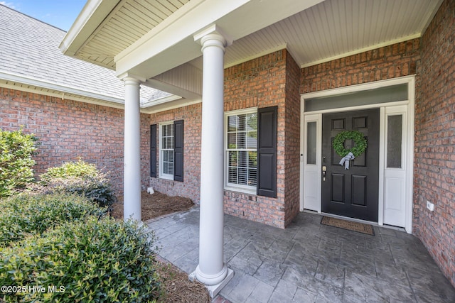 812 Vineyard Dr, New Bern, NC 28562 - view of exterior entry with brick siding and a porch